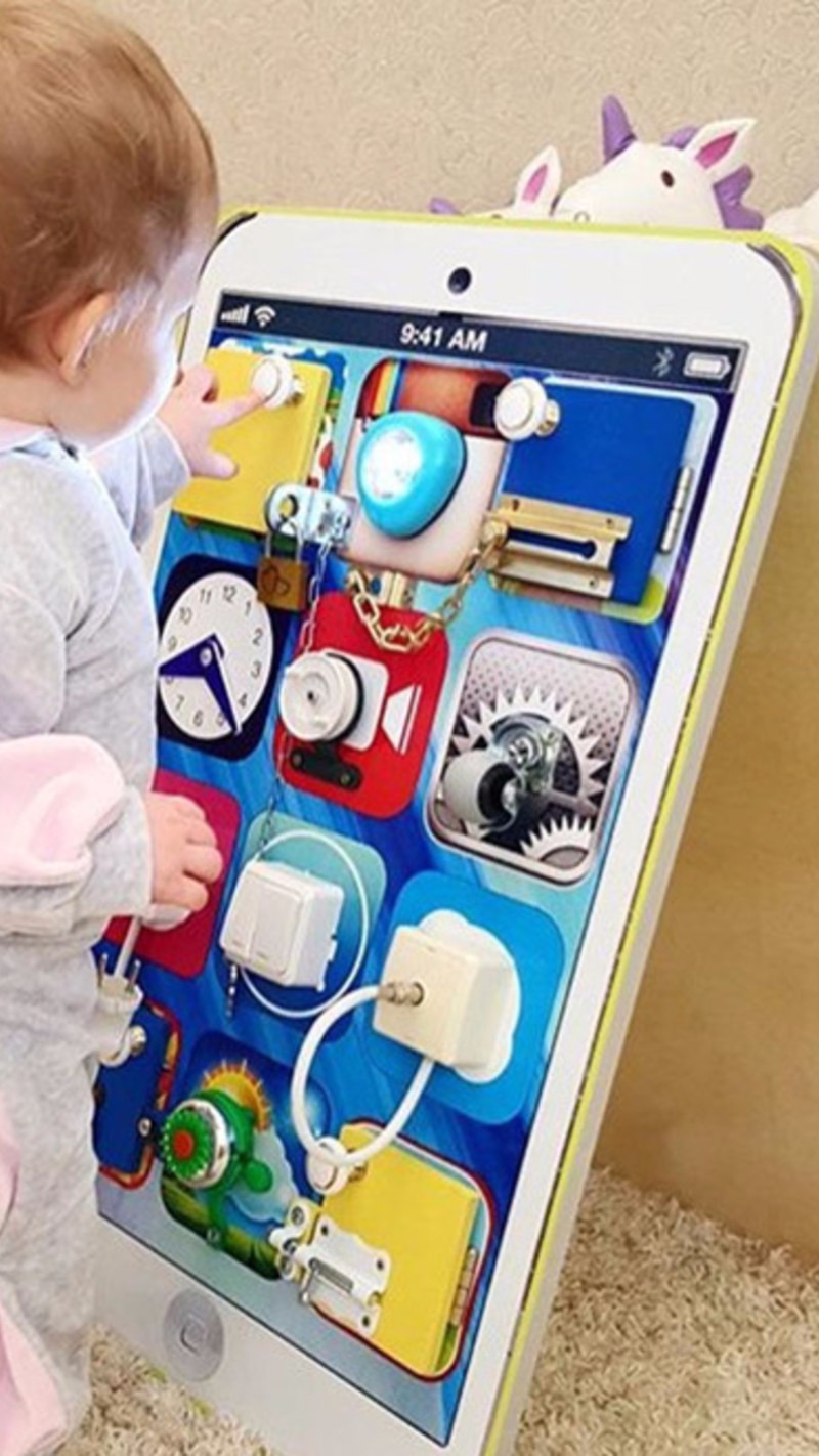 What a UNIQUE toddler busy board idea - they made the sensory activity board look like an iphone!
