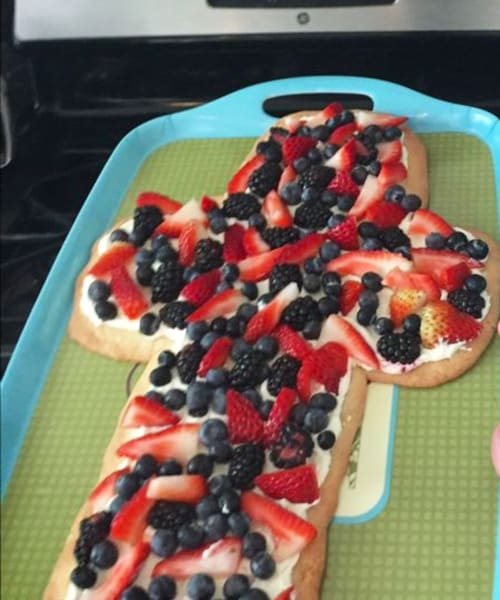 This fruit platter tray shaped like a crowss has a cookie dough crust shaped like a cross with fresh fruit slices on top - crowd pleaser at my Easter brunch potluck at church