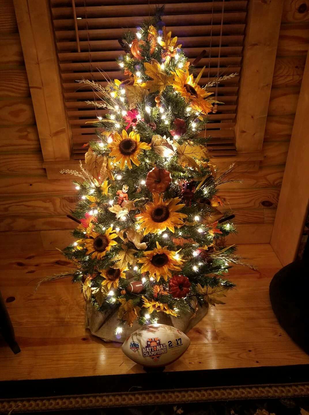 fall themed christmas tree decorating ideas for a miniature small fake tree  - sunflowers, fall leaves and football decorations