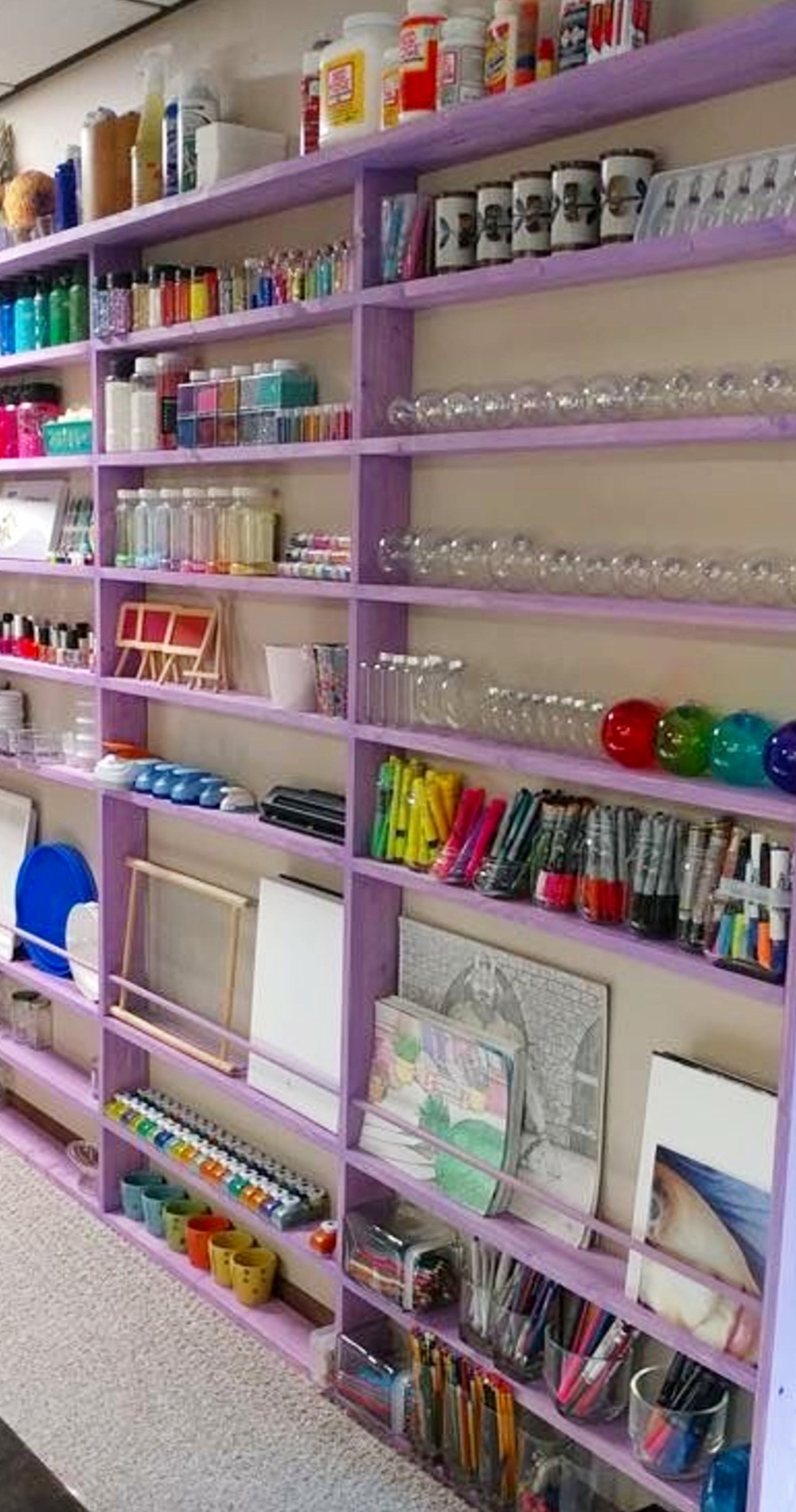 craft room storage wall shelves with organized crafting supplies