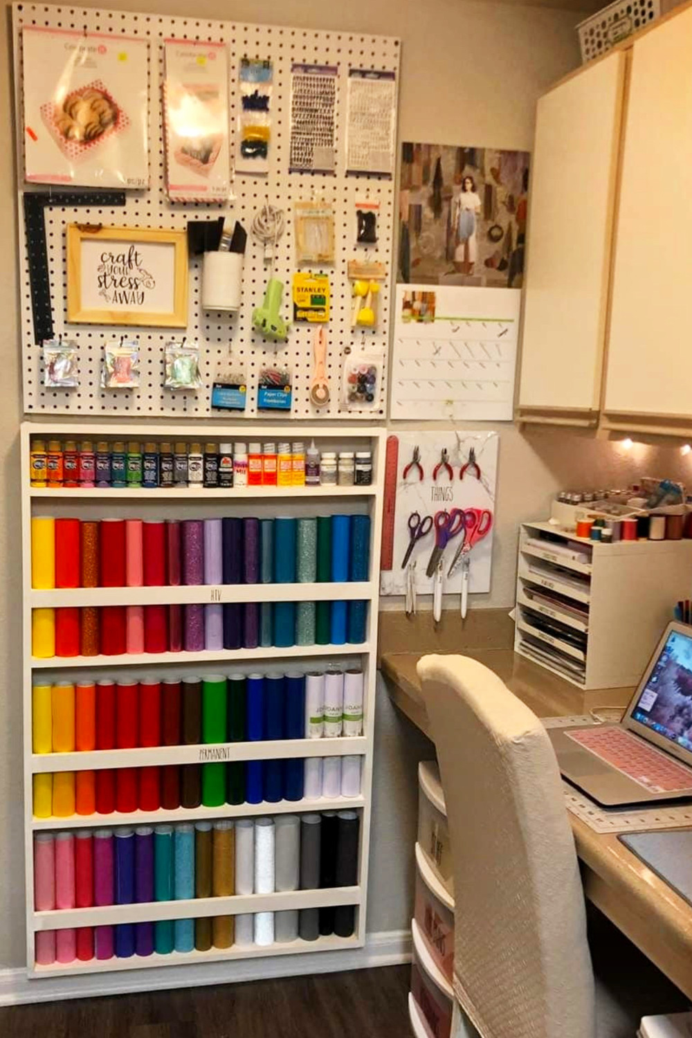 craft room desk with craft peg board wall for storage and organization